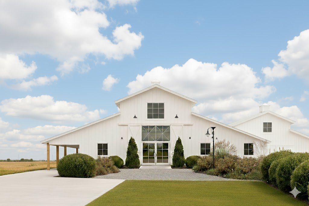 White modern barn venue with a gravel path and green manicured lawn.