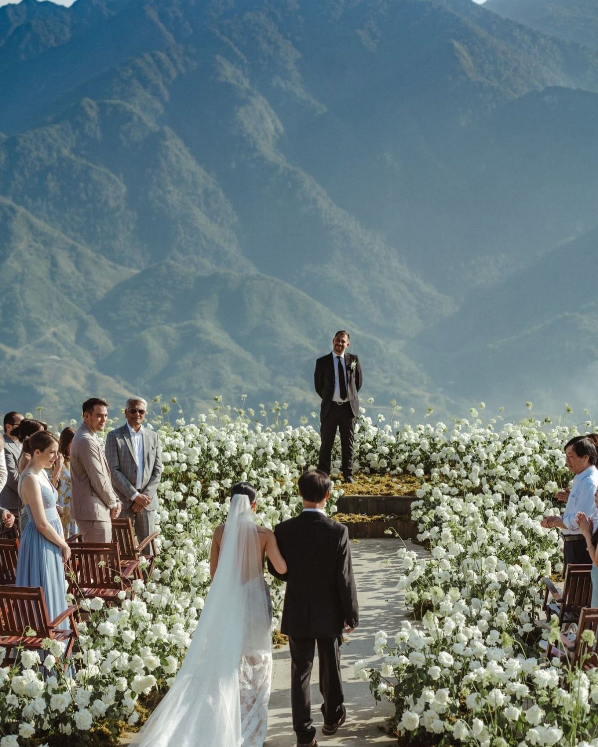 Wedding ceremony with white flowers on a mountain overlook with a scenic backdrop