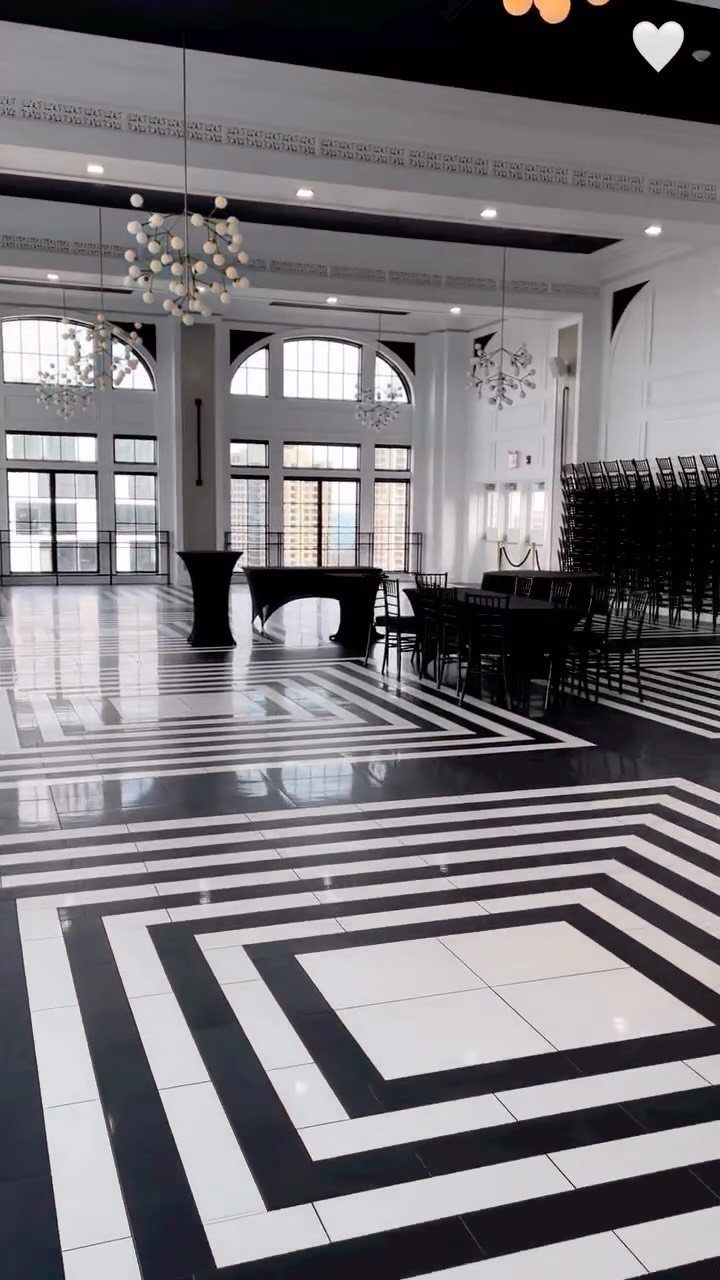 Event venue with black and white geometric floors and city skyline views