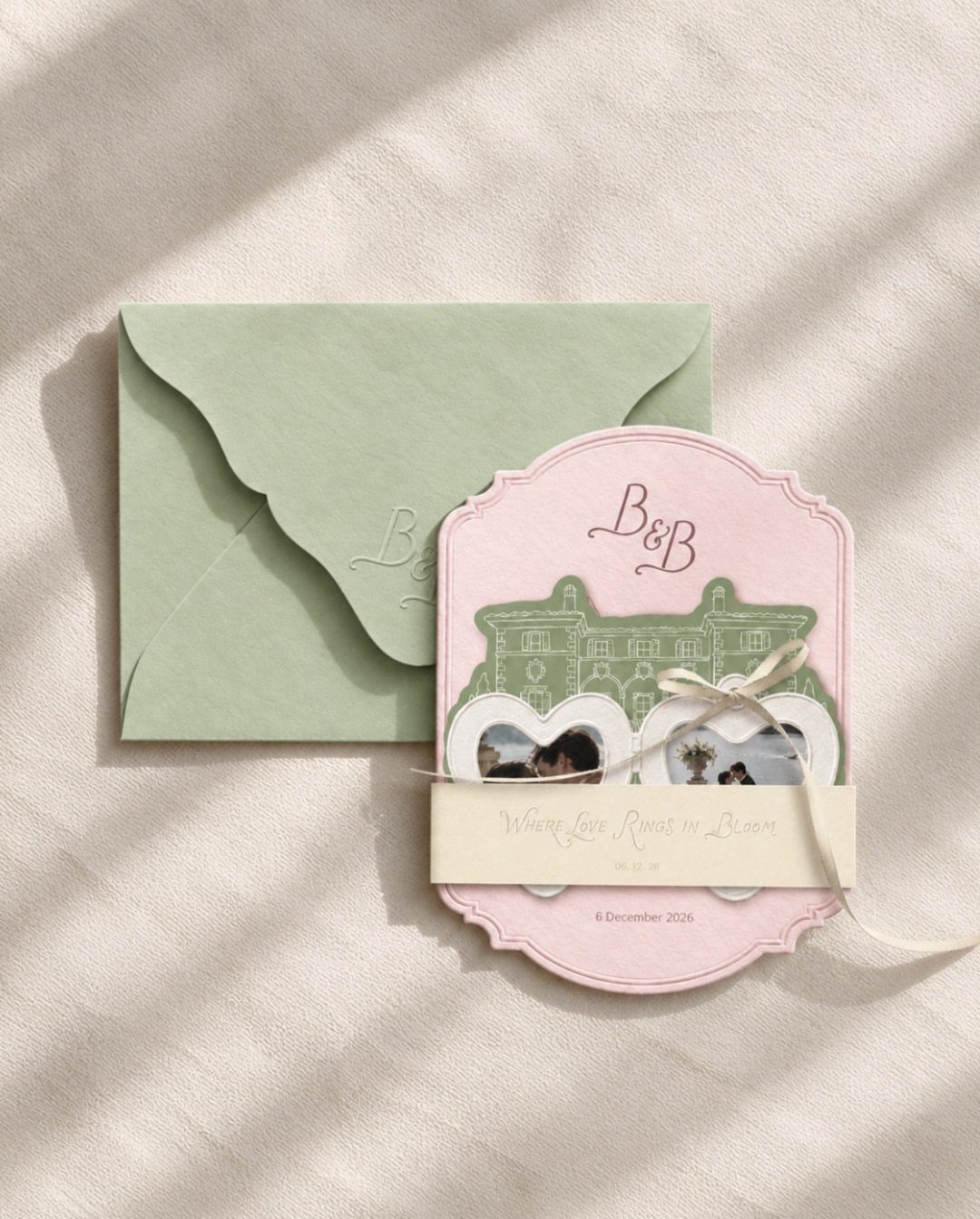 Pink scalloped wedding announcement card with green envelope and small couple photos.