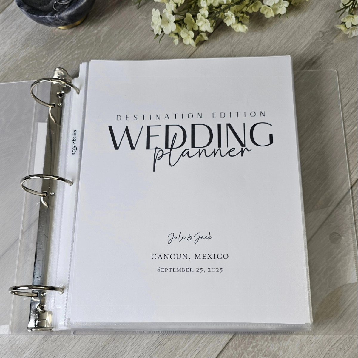 Wedding planner binder with destination edition text on a light wooden surface.
