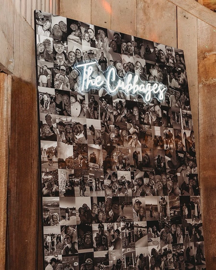 Photo wall of black and white pictures with a white neon sign overlay.