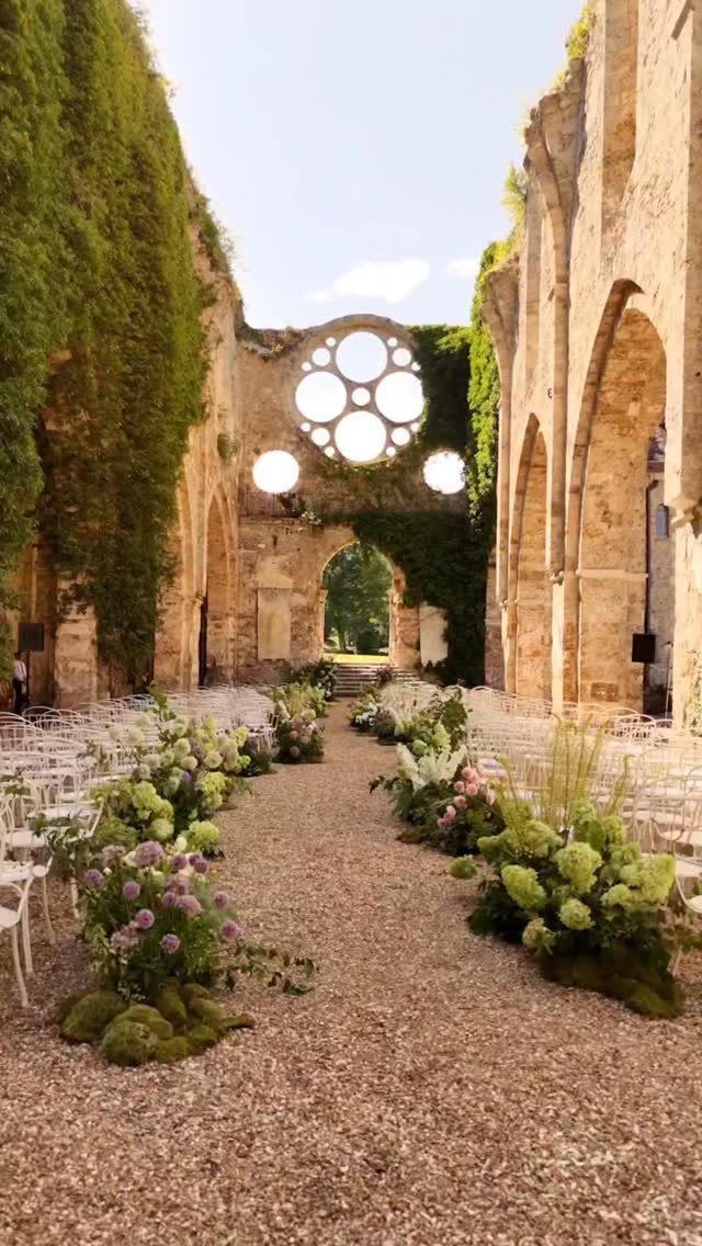 Stone ruins of an ancient building decorated with flowers for a wedding ceremony.