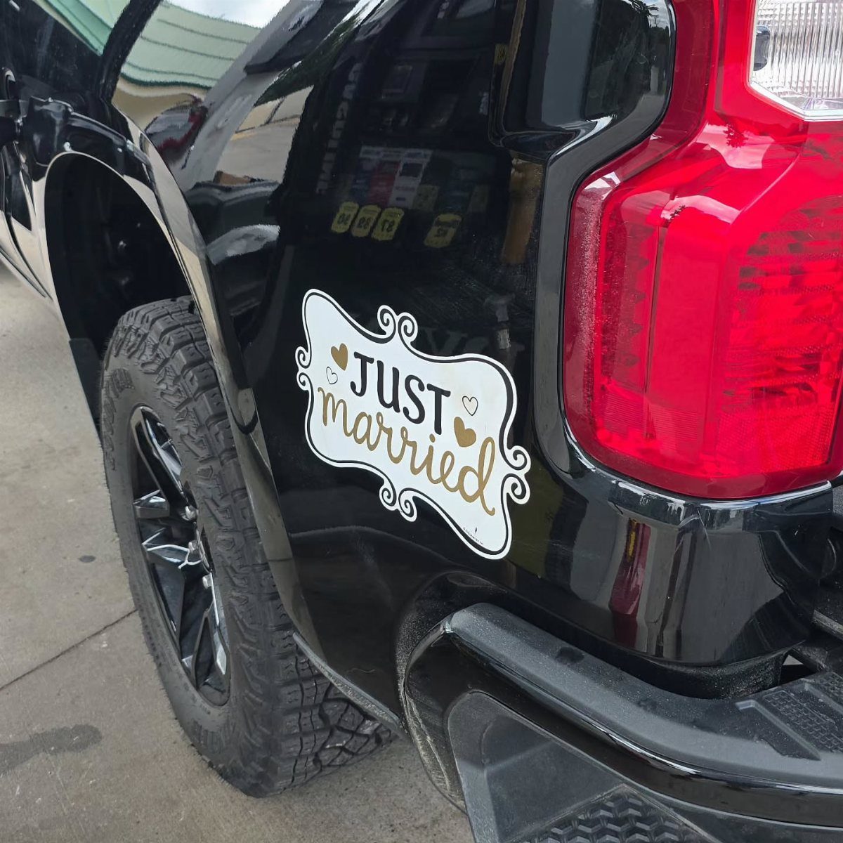 White Just Married magnet on the back of a black pickup truck