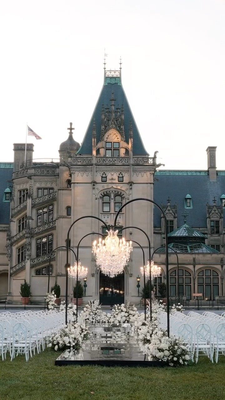 Biltmore Estate chateau with a luxury wedding ceremony setup and crystal chandeliers outdoors.
