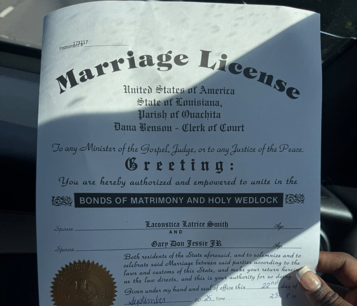 Marriage License document from Louisiana held by a hand, showing formal legal text.