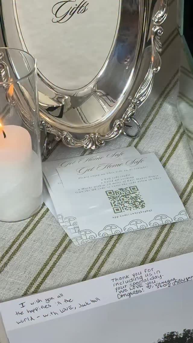 Get Home Safe cards with QR codes next to a candle and gift sign.