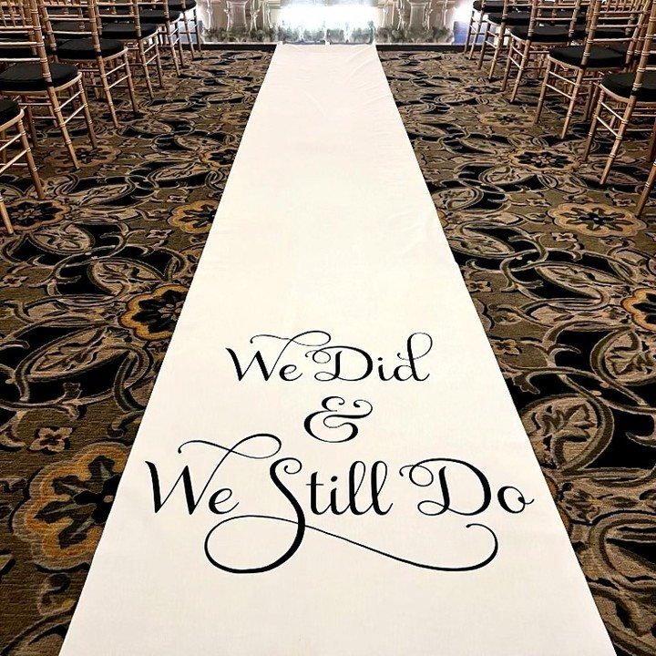 White aisle runner with 'We Did & We Still Do' text between gold chairs.
