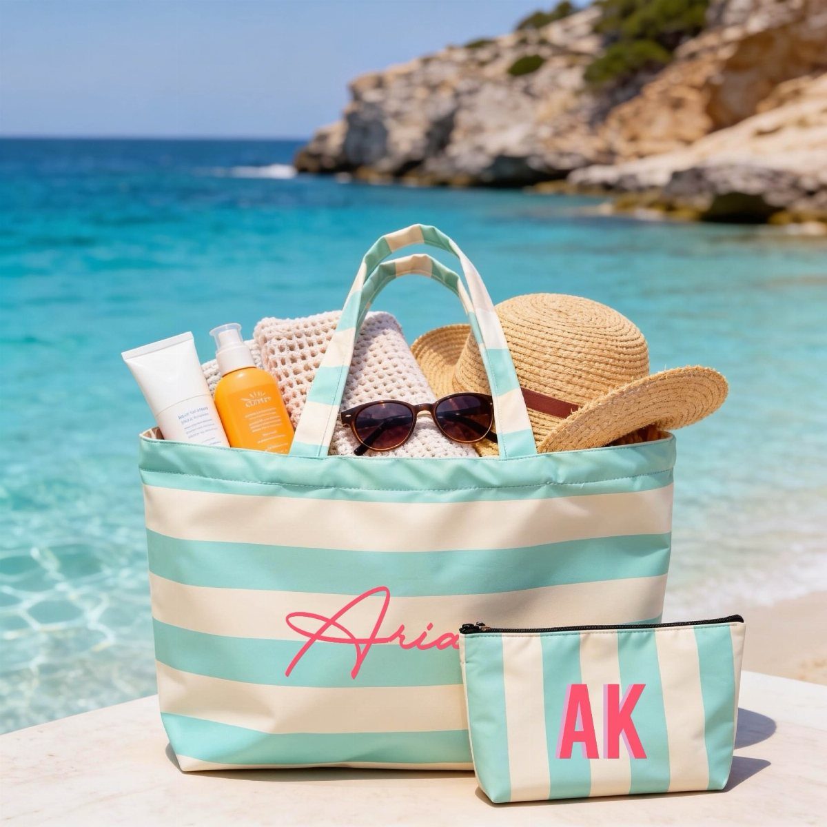 Striped beach tote bag and pouch with personalized names by a turquoise ocean.