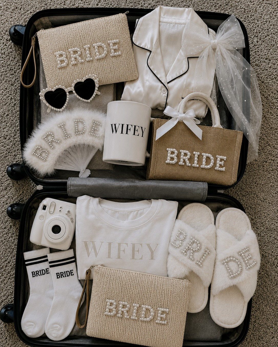 Open black suitcase packed with white bridal accessories and bags labeled Bride and Wifey.