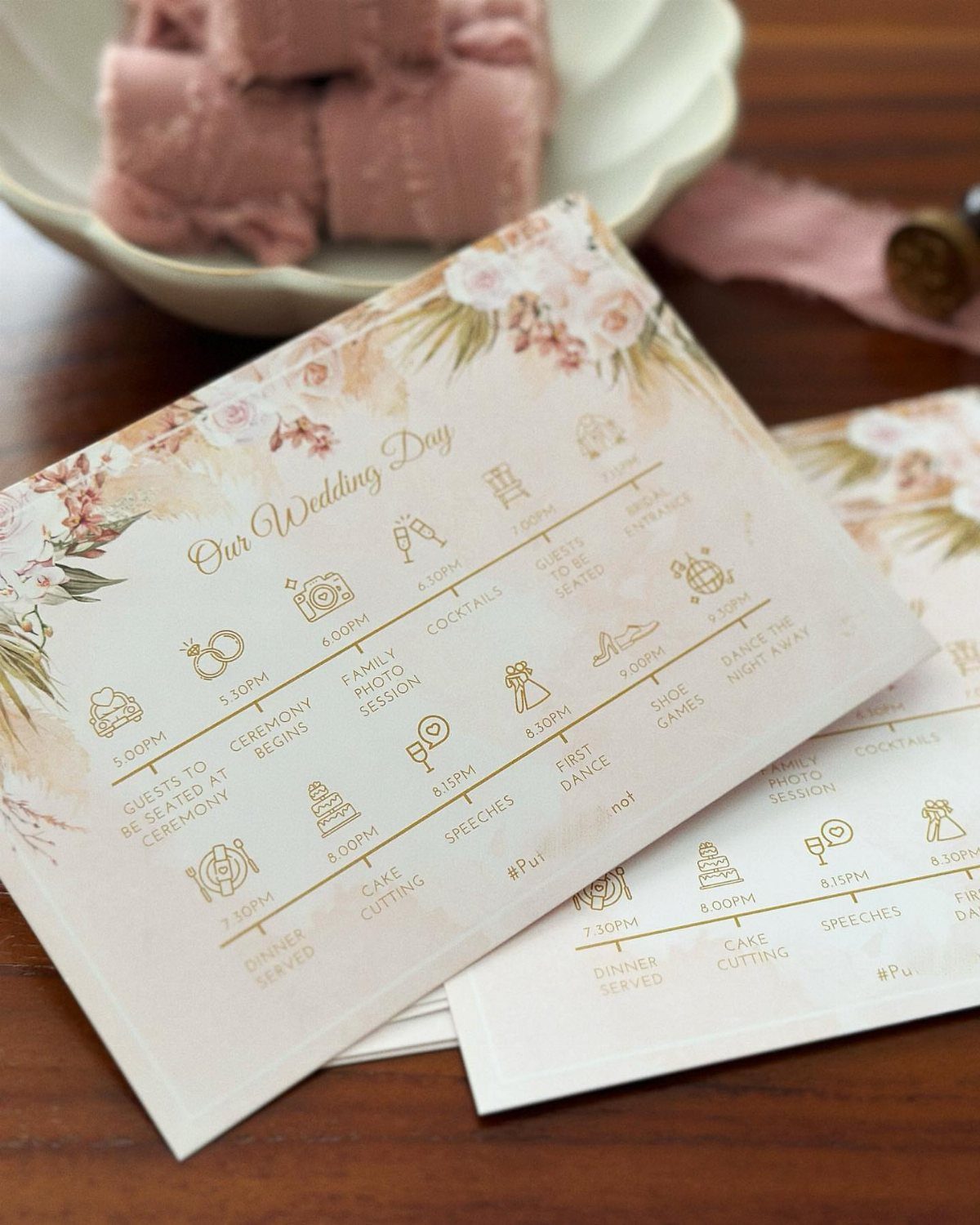 Wedding day itinerary cards with floral designs and a timeline of events.